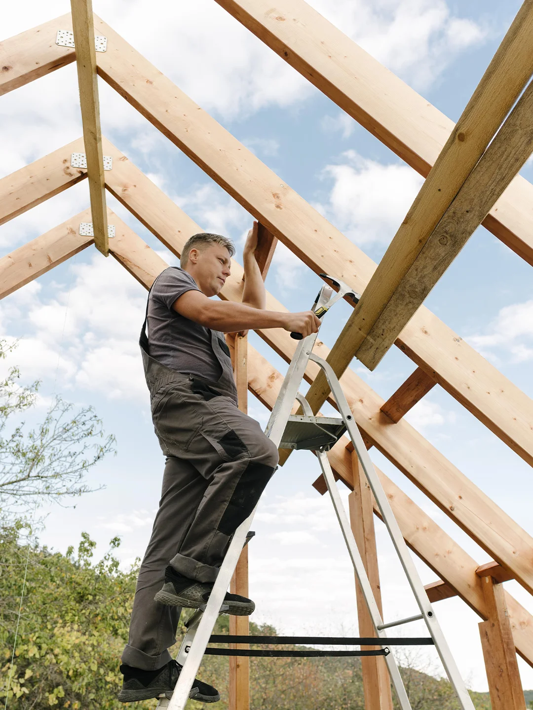 Worker framing a roof structure